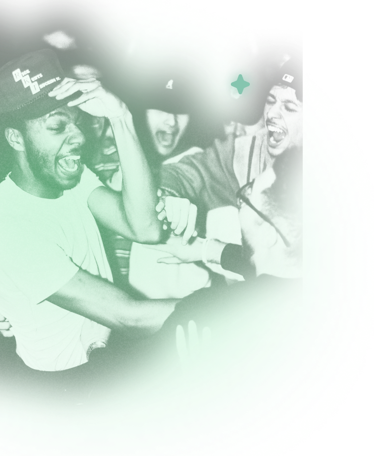 A man in a white crew neck t-shirt wearing a black cap